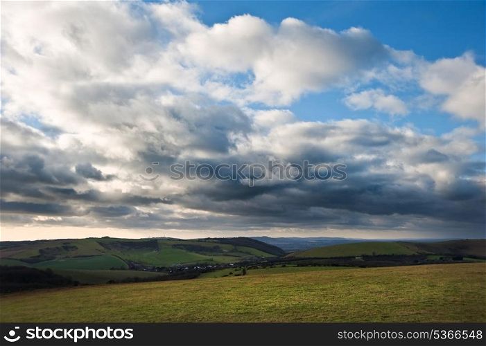 Stunning cloud formations during stormy sky over countryside landscape with vibrant colors