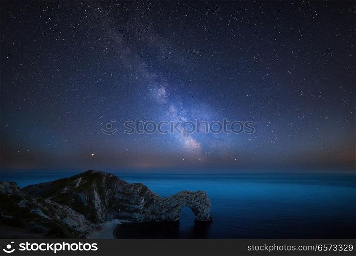 Stunning colorful image of Milky Way galaxy over sea landscape in Dorset England