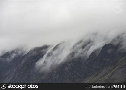Stunning dramatic Lake District landscape image of thick low cloud hanging over Illgill Head in wasdale Valley giving a very effective image