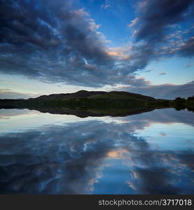 Stunning dramatic sunrise over calm lake