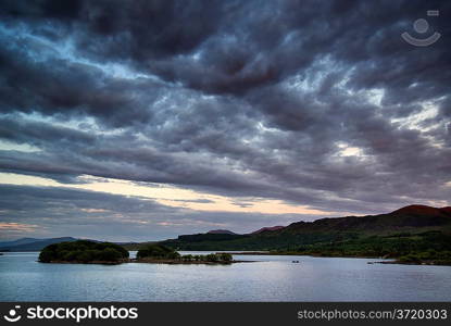 Stunning dramatic sunrise over calm lake