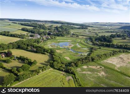 Stunning drone landscape image over lush green Summer English countryside during late afternoon light