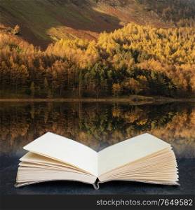 Stunning epic Autumn Fall landscape Buttermere in Lake District with beautiful early morning sunlight playing across the hills and mountains in pages of open fantasy book