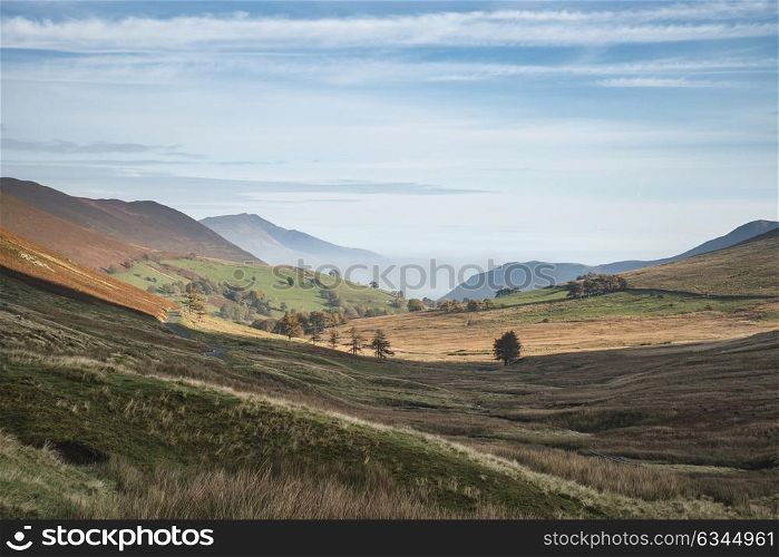 Stunning foggy Autumn Fall sunrise landscape image over countryside in Lake District in England