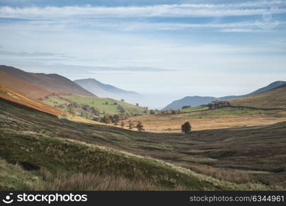 Stunning foggy Autumn Fall sunrise landscape image over countryside in Lake District in England