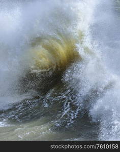 Stunning image of individual wave breaking and cresting during violent windy storm with superb wave detail