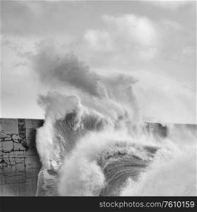Stunning image of individual wave breaking and cresting during violent windy storm in black and white with superb detail