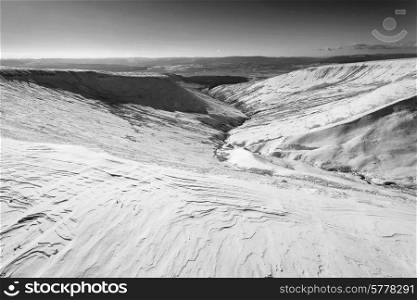 Stunning landscape of snow covered mountains in Winter in black and white