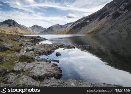 Stunning landscape of Wast Water and Lake District Peaks on Summer day reflected in perfect lake