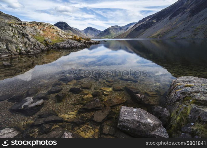 Stunning landscape of Wast Water with mountains reflected in calm lake water in Lake District