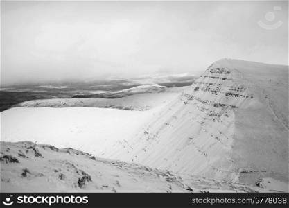 Stunning landscapeof snow covered mountains in black and white