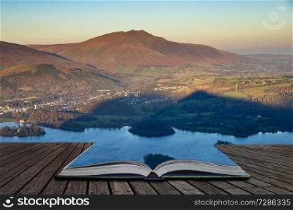 Stunning late afternoon Autumn Fall landscape image of the view from Catbells near Derwent Water in the Lake District coming out of pages of open story book
