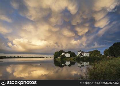 Stunning mammatus clouds formation over lake landscape immediately prior to violent storm