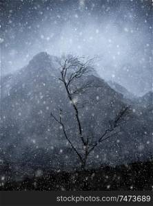 Stunning moody dramatic Winter landscape mountain image of snowcapped Y Garn in Snowdonia