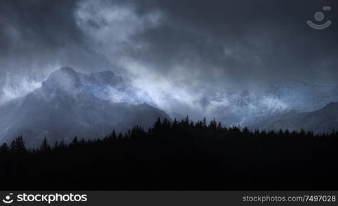 Stunning moody dramatic Winter landscape mountain image of snowcapped Y Garn in Snowdonia