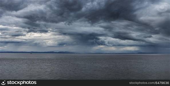 Stunning moody stormy sky over sea landscape. Stunning dramatic stormy sky over sea landscape