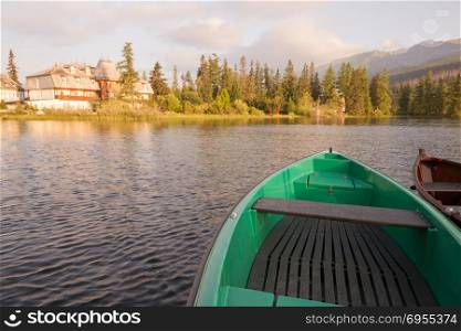 Stunning mountain lake with colorful wooden boats. Stunning mountain lake with colorful wooden boat. National Park High Tatras, Strbske Pleso, Slovakia, Europe