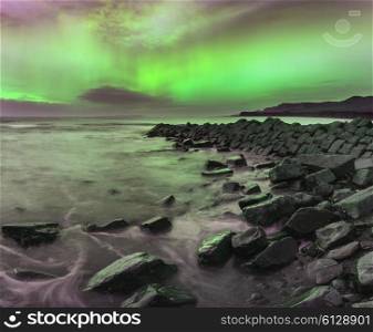 Stunning Northern Lights Aurora Borealis over coastal landscape