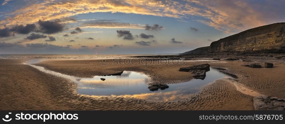Stunning panorama sunset landscape over Dunraven Bay in Wales