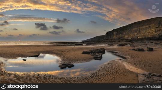 Stunning panorama sunset landscape over Dunraven Bay in Wales