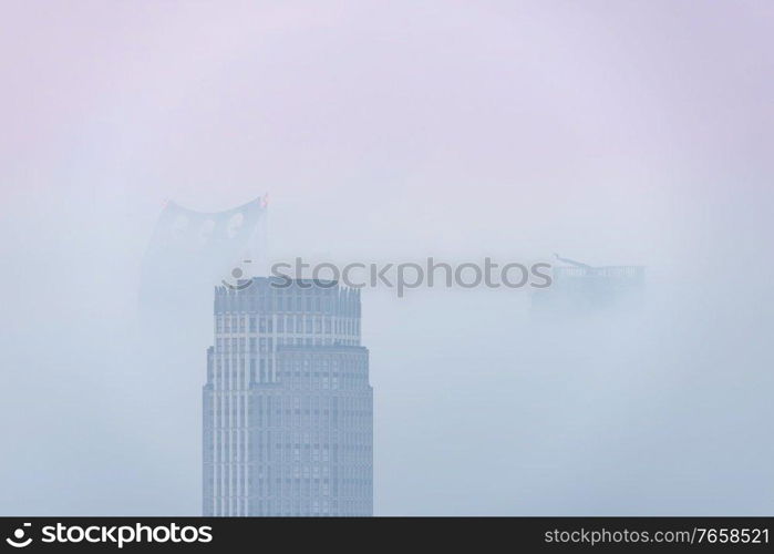 Stunning sunrise landscape image of fog above London city landmarks with besutiful soft light on skyscrapers