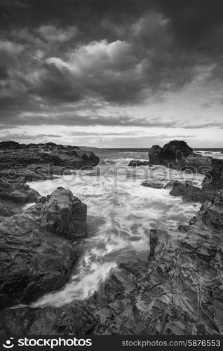 Stunning sunrise landscape of Godrevy on Cornwall coastline in England black and white