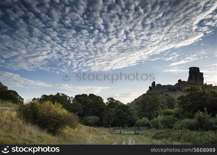 Stunning sunrise landscape over ruins of medieval castle