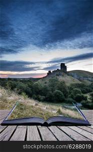 Stunning sunrise landscape over ruins of medieval castle conceptual book image