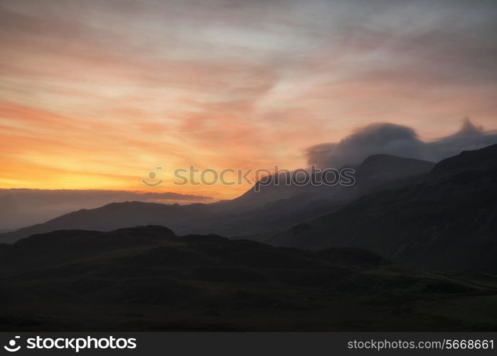 Stunning sunrise mountain landscape with vibrant colors and beautiful cloud formations
