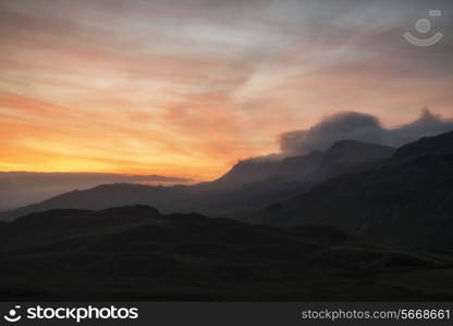 Stunning sunrise mountain landscape with vibrant colors and beautiful cloud formations