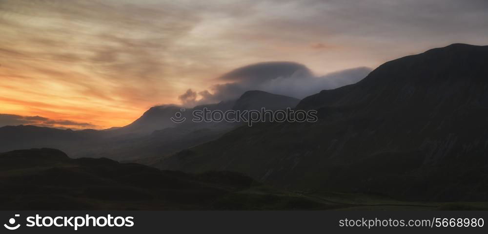 Stunning sunrise mountain landscape with vibrant colors and beautiful cloud formations
