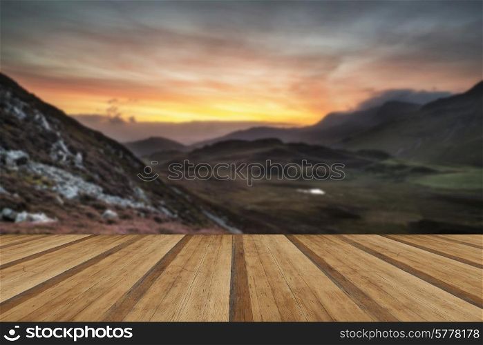 Stunning sunrise mountain landscape with vibrant colors and beautiful cloud formations with wooden planks floor