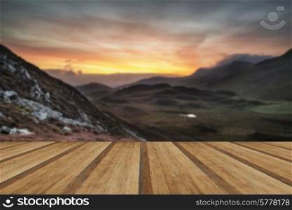 Stunning sunrise mountain landscape with vibrant colors and beautiful cloud formations with wooden planks floor