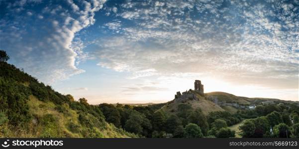Stunning sunrise panorama landscape over ruins of medieval castle