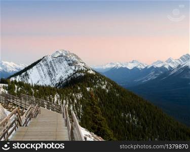 Stunning sunset Canadian rocky mountains and boardwalk on Sulphur Mountain connect to Gondola landing in Banff, Canada. Gondola ride to Sulphur Moutain overlooks the Bow Valley and the town of Banff.