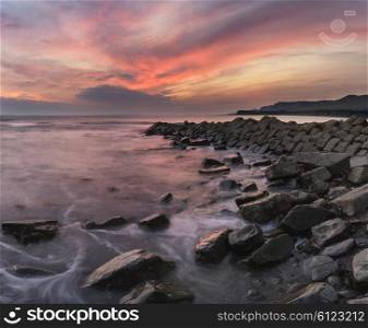 Stunning sunset landscape image of rocky coastline in Dorset England