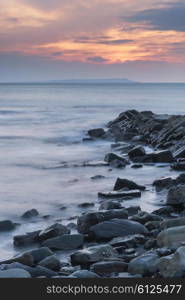 Stunning sunset landscape image of rocky coastline in Dorset England