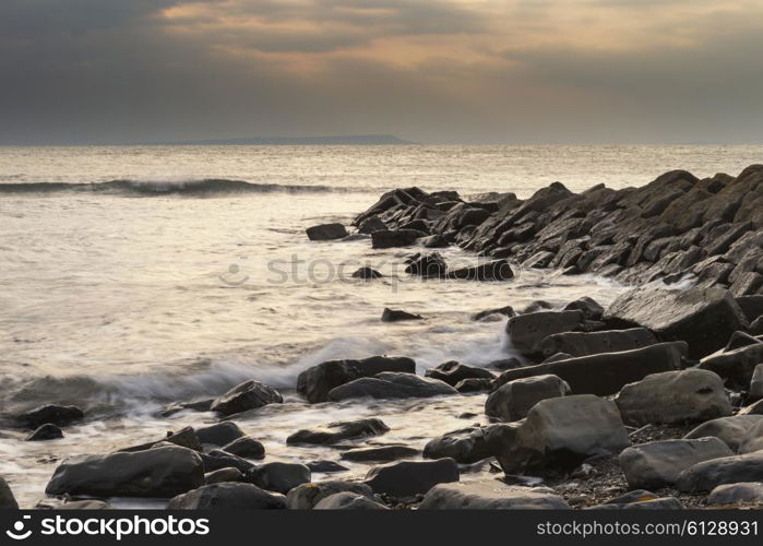 Stunning sunset landscape image of rocky coastline in Dorset England