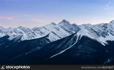 Stunning sunset of snow capped Canadian Rocky mountains at Banff National Park in Alberta, Canada. View from Banff Gondola Sulphur Moutain.