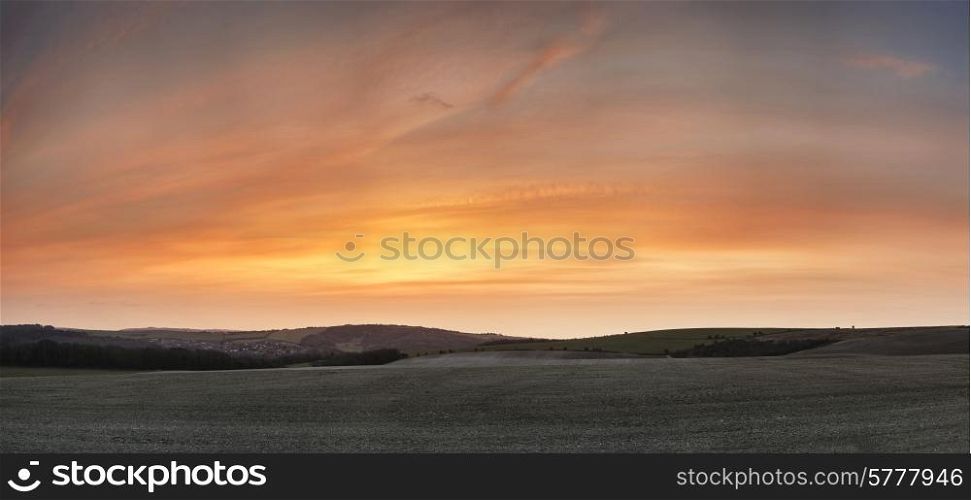 Stunning sunset over farm landscape with vibrant coors