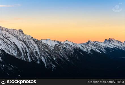 Stunning sunset scene of snow capped Canadian Rocky mountains at Banff National Park in Alberta, Canada. View from Banff Gondola Sulphur Moutain.