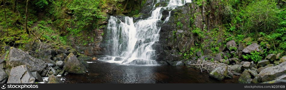 stunning Torc waterfall in the Killarney National Park, Ireland (panoramic picture with 180 angle view)