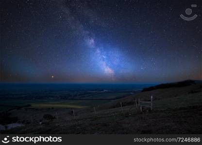 Stunning vibrant Milky Way composite image over landscape of countryside in Summer