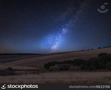Stunning vibrant Milky Way composite image over landscape of English countryside 