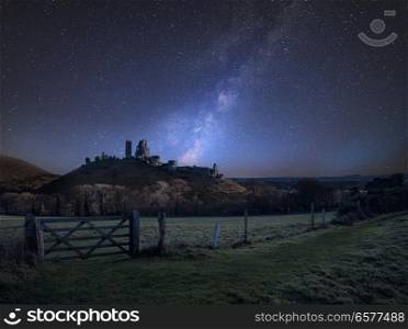 Stunning vibrant Milky Way composite image over landscape of Medieval castle ruins. UK
