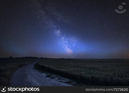 Stunning vibrant Milky Way composite image over landscape of Steyning Bowl on South Downs