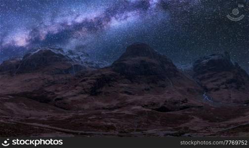 Stunning vibrant Milky Way composite image over landscape of Three Sisters mountains in Glencoe in Scottish Highlands