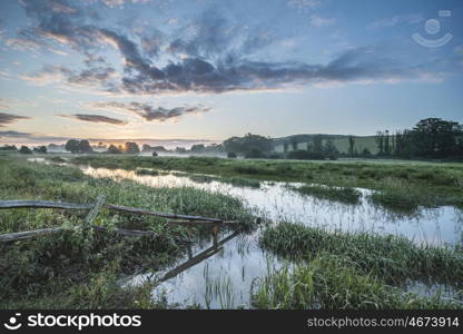 Stunning vibrant Summer sunrise over English countryside landscape