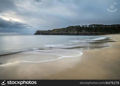 Stunning, vibrant sunrise landscape image of Barafundle Bay on P. Beautiful sunrise landscape image of Barafundle Bay on Pembrokeshire Coast in Wales