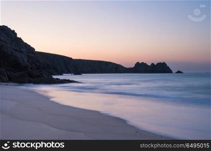 Stunning vibrant sunrise landscape image of Porthcurno beach on . Beautiful colorful sunrise landscape image of Porthcurno beach on South Cornwall coast in England